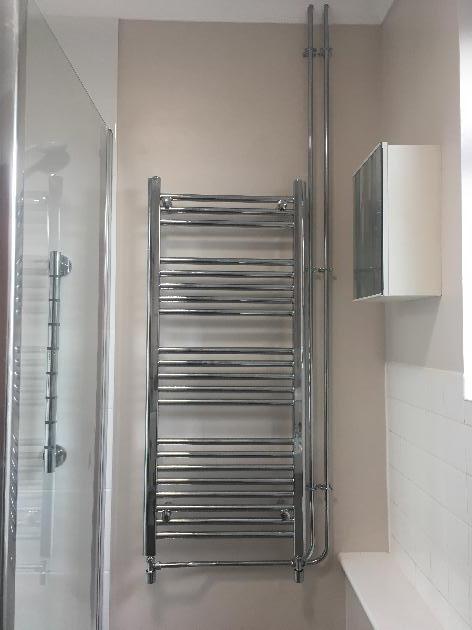 Towel rail with exposed chrome pipework
